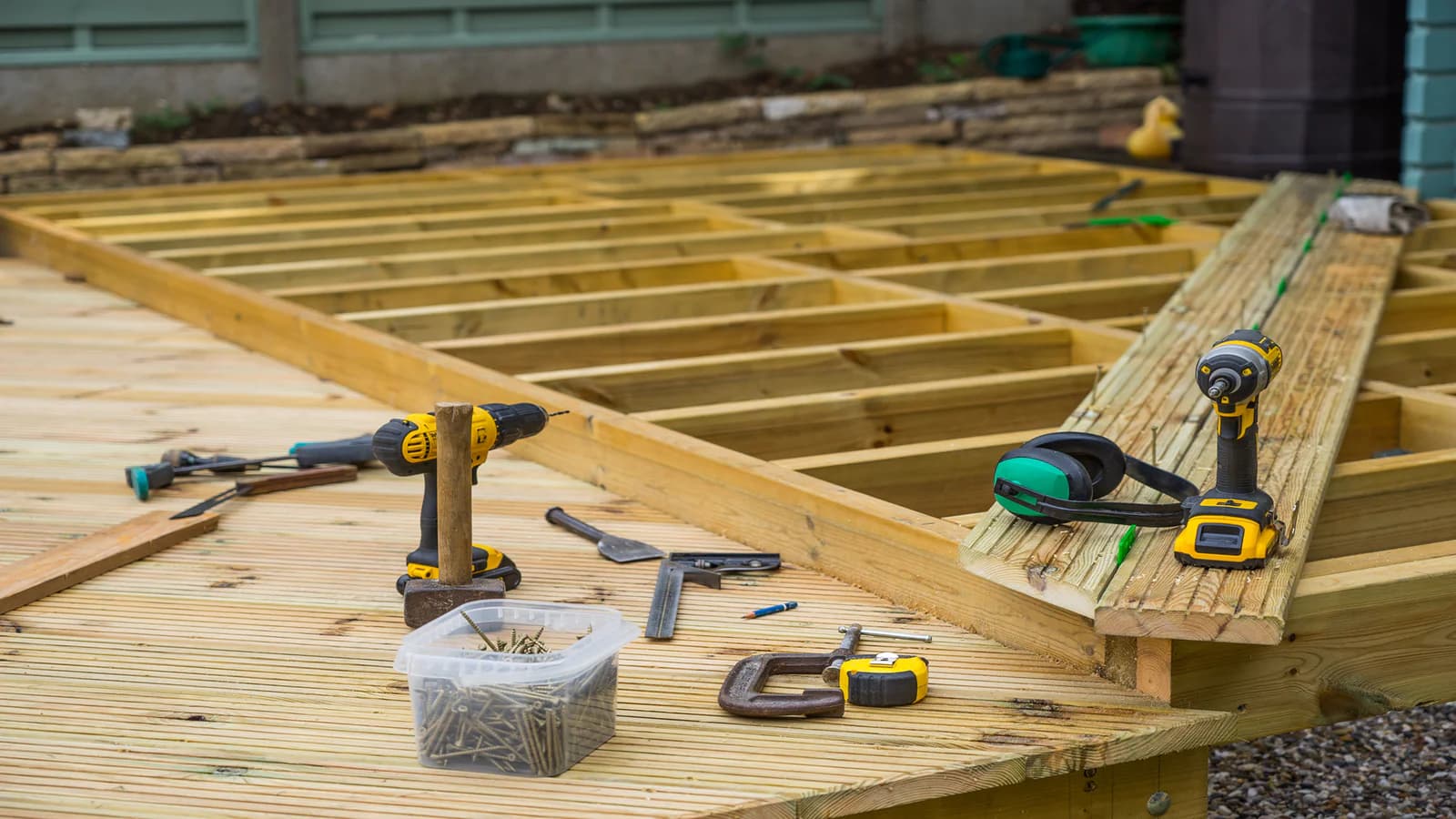 Custom outdoor deck construction with railings and stairs